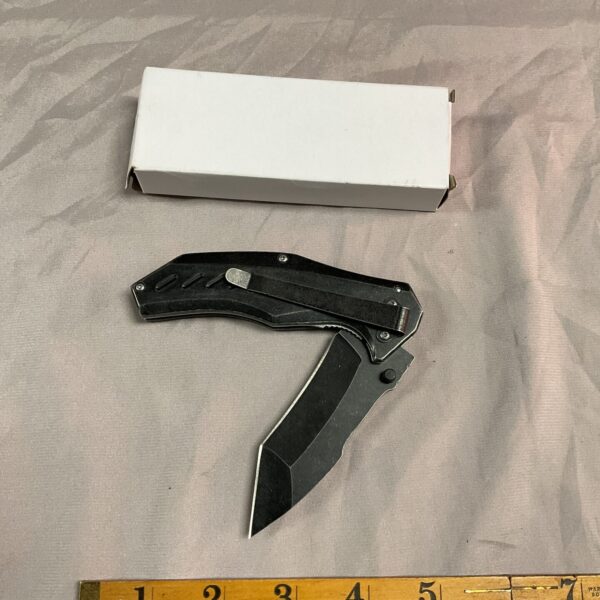 Black handled D2 pocket knife with serrated blade.