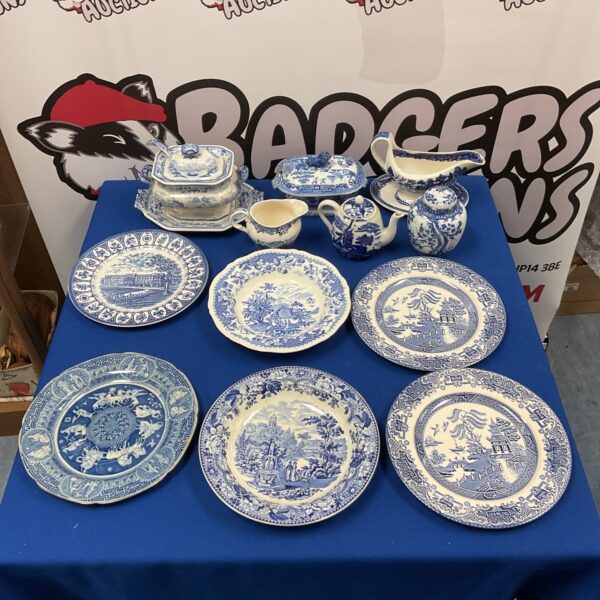 Vintage blue and white china collection with teapot and plates.