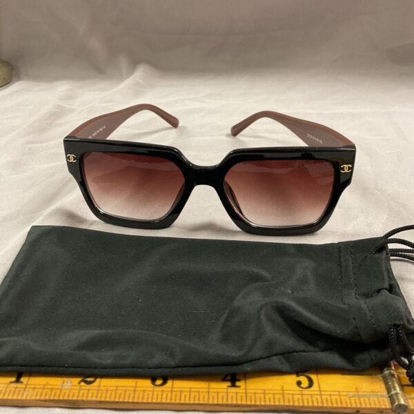 Vintage Chanel style cat eye glasses with dark lenses.