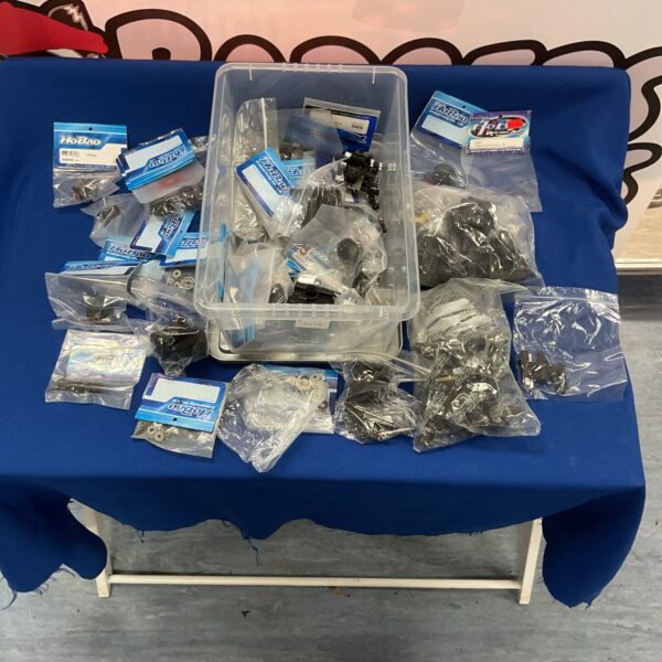 New RC car parts lot with various components and gears.