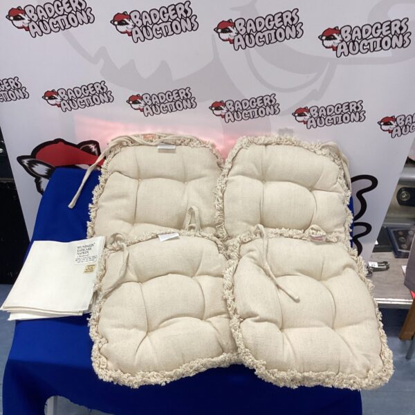 Four tied chair cushions for kitchen or dining use.