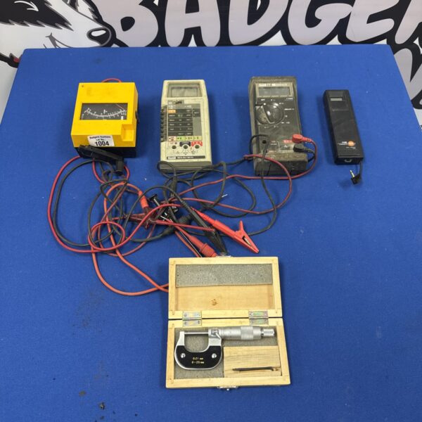 Assorted electrical testers including a Fluke model and micrometer.