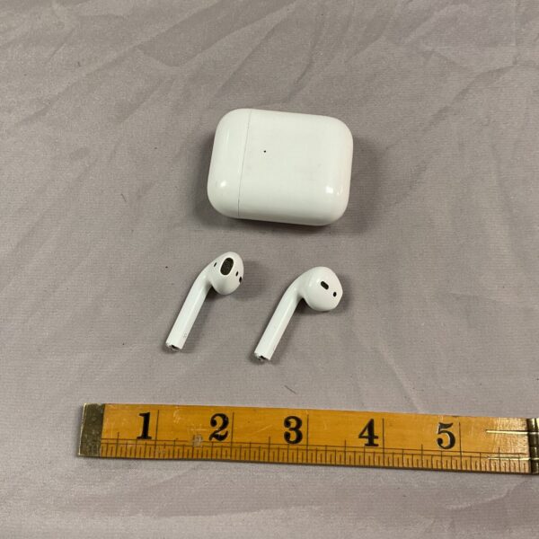 White Apple AirPods first generation case and earbuds on a white surface.