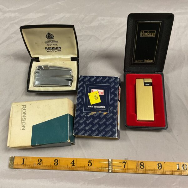 Vintage Ronson Varaflame and Hadson gas lighters in original packaging.