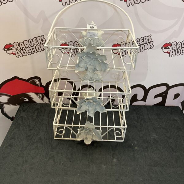 Vintage hanging floral wire storage rack for home organization.
