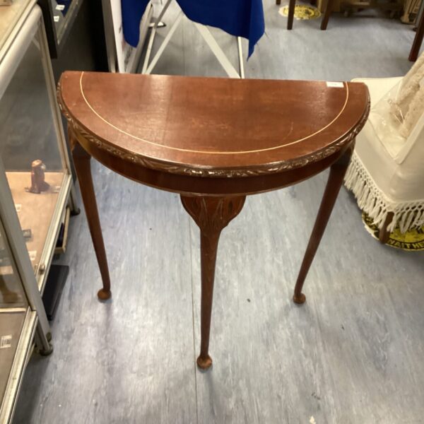 Antique mahogany demi lune side table with curved front.