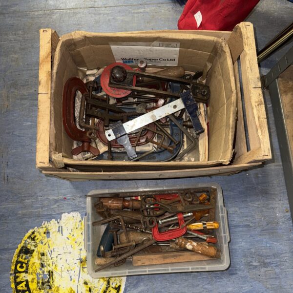 Vintage tool lot with clamps and metal implements.