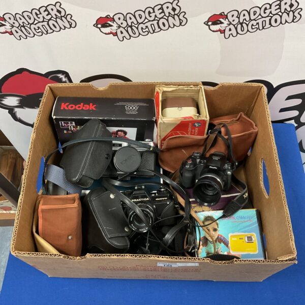 Vintage camera lot featuring Yashica and Praktica film cameras.