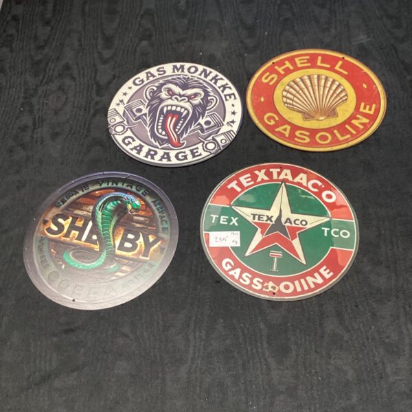 Lot of four vintage gasoline tin signs for collectors.