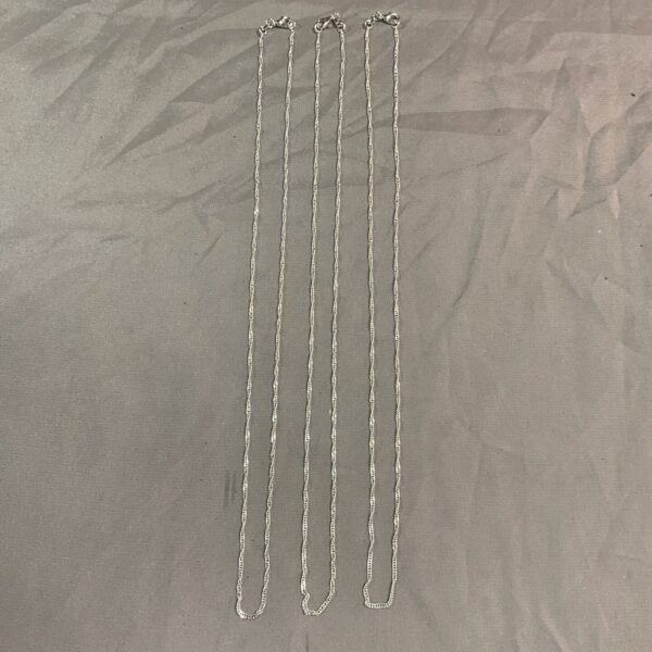 Lot of three 925 silver necklaces on a measuring tape.