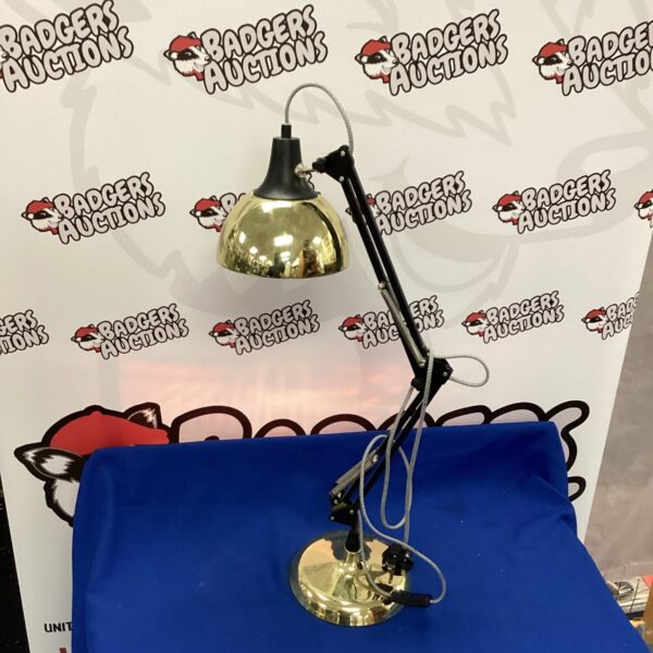 Rose gold Anglepoise style desk lamp with adjustable arms.