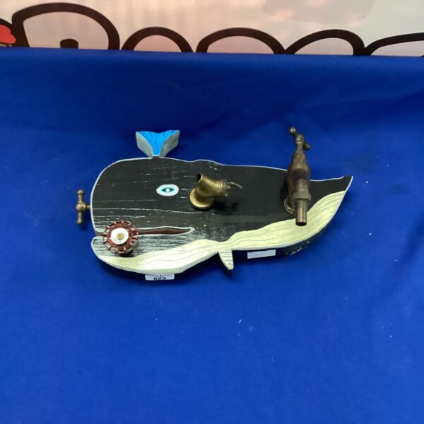 Vintage metal whale wall art sculpture for nautical decor.