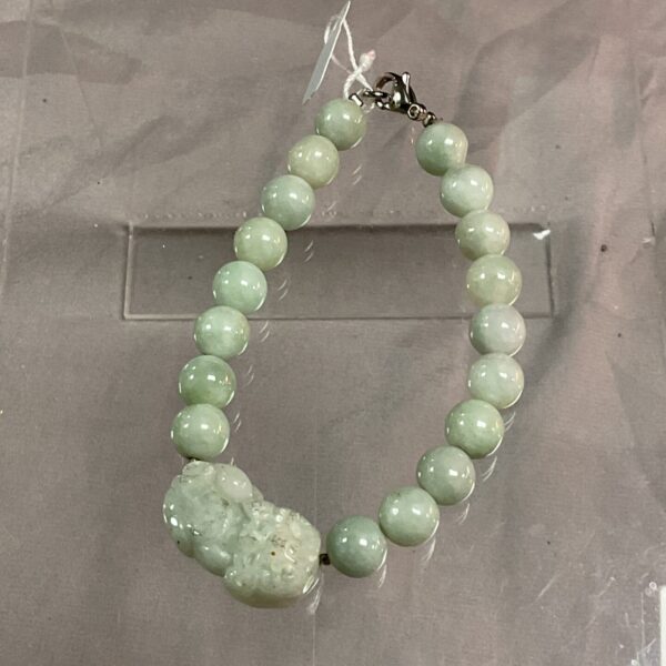 Vibrant green jade bracelet with round and textured beads.