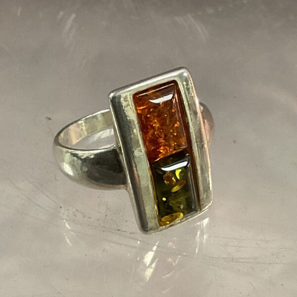 Close-up of a 925 silver ring with amber stone.