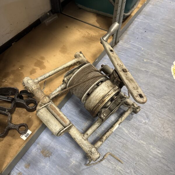 Close-up of a vintage WW2 aircraft winch with cable drum.