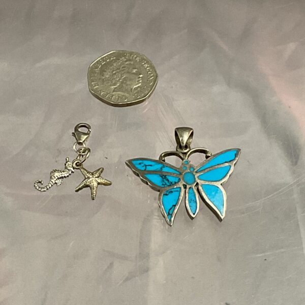 Silver butterfly pendant with seahorse and starfish charm