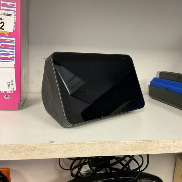 Black Amazon Alexa Show smart speaker on a surface.