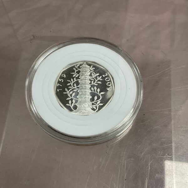 Front view of the 2009 Kew Gardens 50p coin in a capsule.