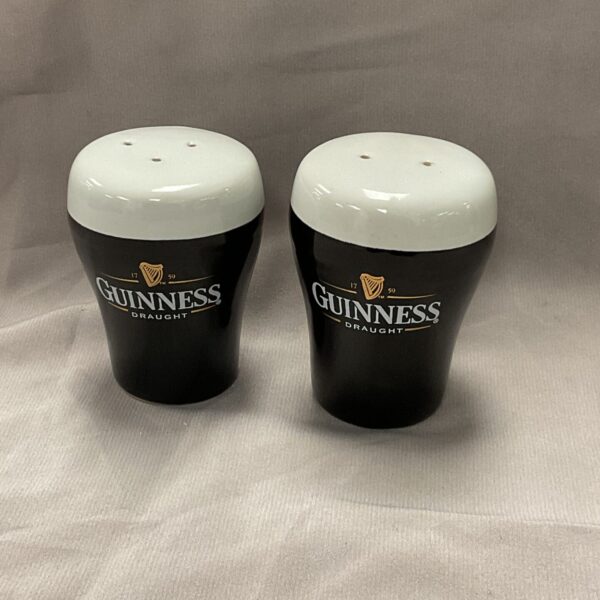 White ceramic Guinness salt and pepper pots with harp logo.