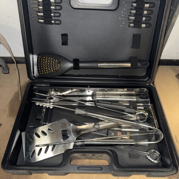 Stainless steel barbecue utensil set in a black carrying case.