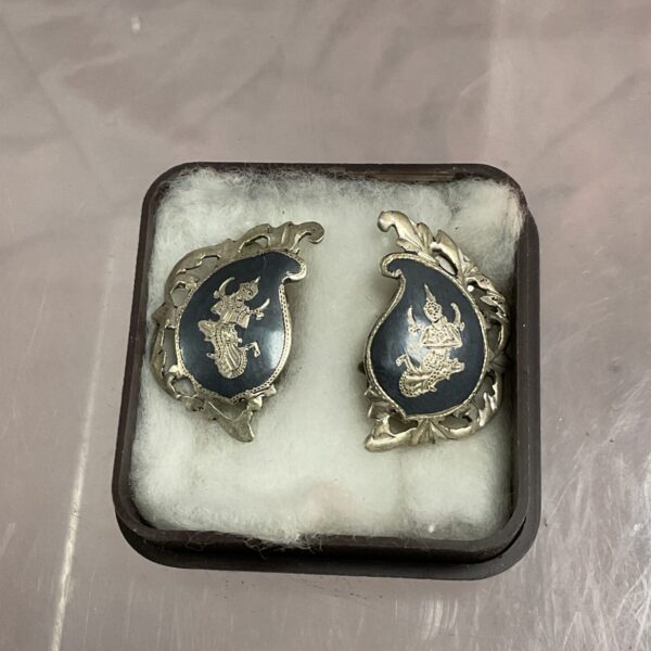Vintage Siam sterling silver clip-on earrings with dark stone detail.