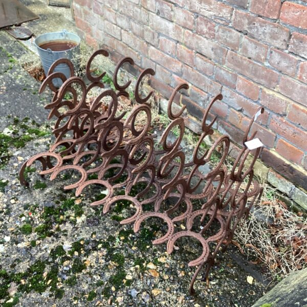 Vintage horseshoe boot stand for rustic farmhouse decor.