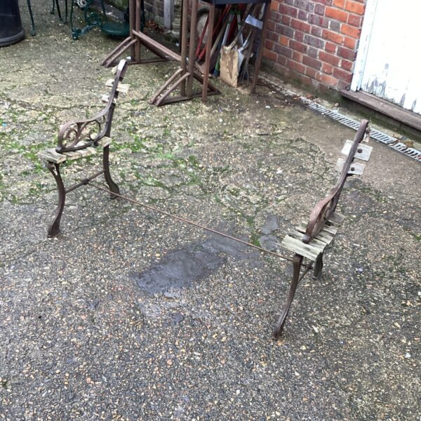 Antique wrought iron garden bench ends for restoration.