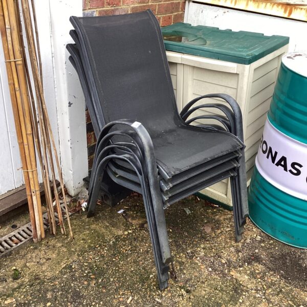 Set of four black garden chairs for outdoor use.