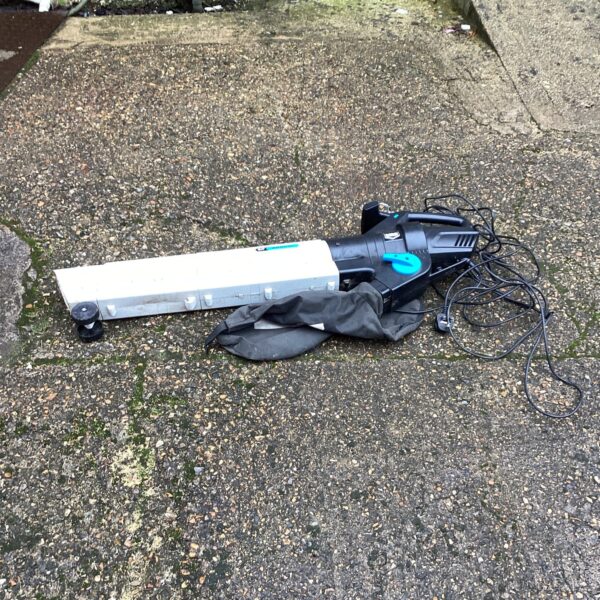 Side view of a used Mac Alister electric lawn vac.