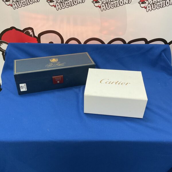 Empty Pol Roger and Cartier presentation boxes for collectors.