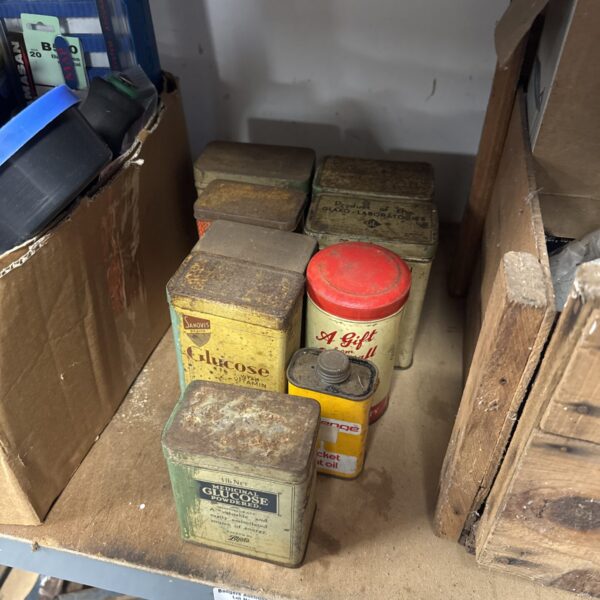 Vintage tin collection with nails and tacks contents.