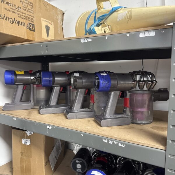 Lot of four Dyson handheld vacuum cleaner bodies for repair.