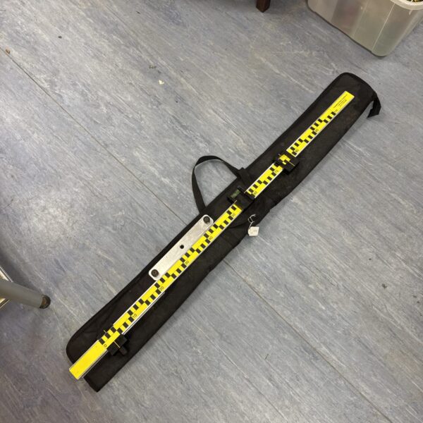 Vintage surveyors level with yellow and black markings for accurate measurements.