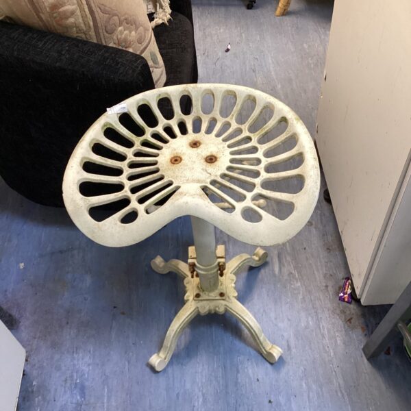 Vintage tractor seat stool with fluted metal seat.