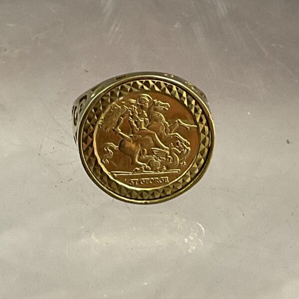 Close-up of 9ct gold St George ring with embossed coin design.