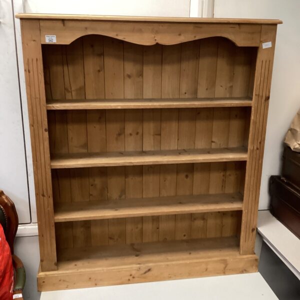 Vintage pine bookcase with open shelving for books and decor.