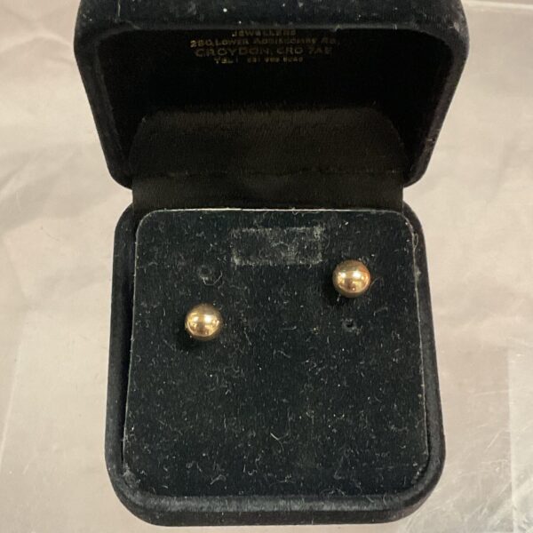 Polished 9ct gold ball stud earrings on a display card.