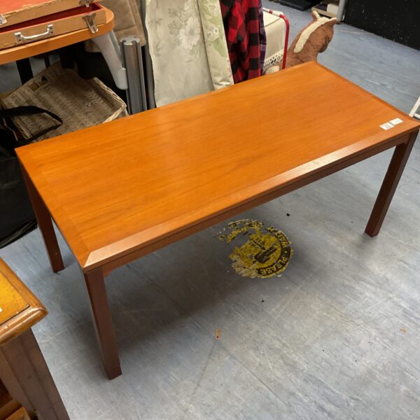 Vintage teak coffee table with warm wood tones.
