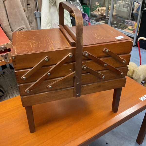 Vintage wooden cantilever sewing box with tiered compartments.