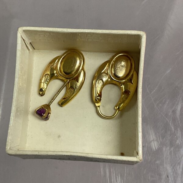 Close-up of 9ct gold earrings offered as scrap gold.