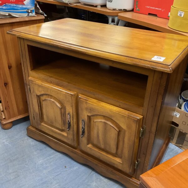 Small oak media cabinet with two doors and open shelf.