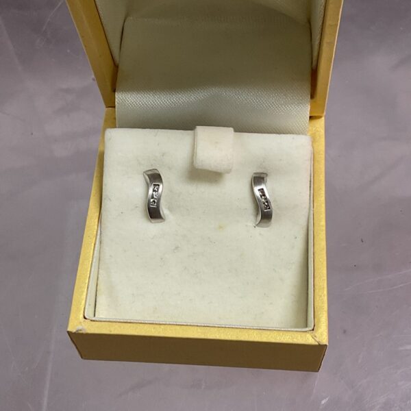 Pair of 9ct white gold stud earrings in a presentation box.