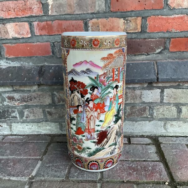 Antique Japanese porcelain stick stand with vibrant floral design.