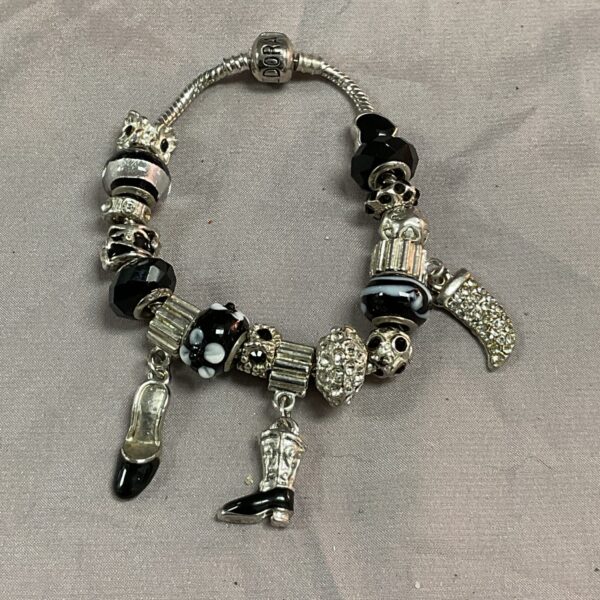 Silver tone Pandora style bracelet with detailed charms.