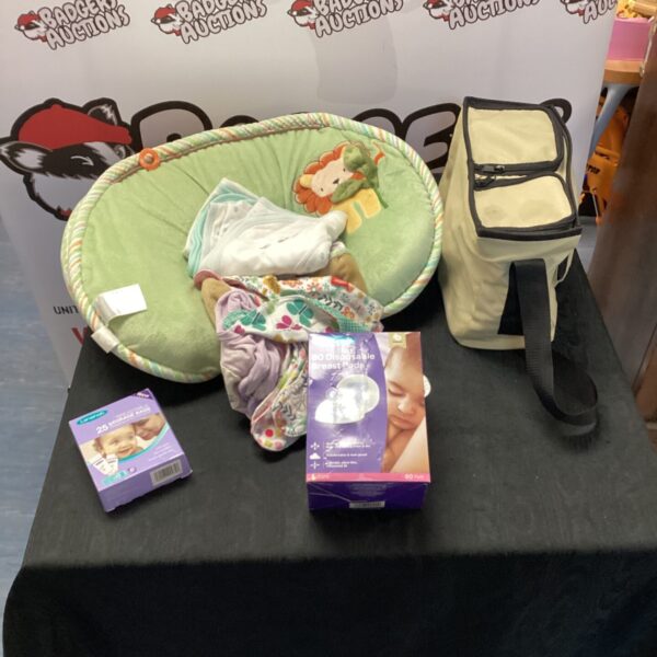 Baby items bundle including a breast pump and clothes.