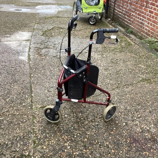Front view of a three-wheeled walking aid trolley.