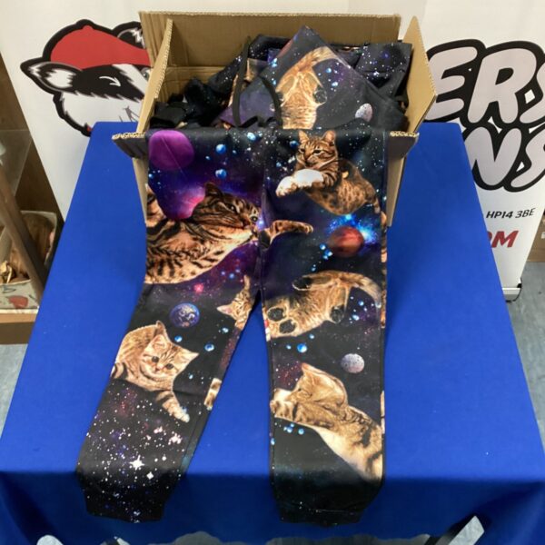 Colourful kids space cat trousers with a vibrant print.