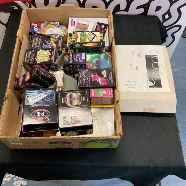 Assortment of colourful boxed magic toys and illusion sets.