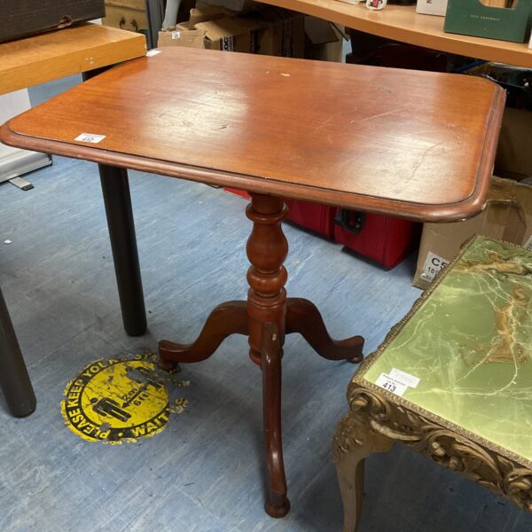 Vintage teak tripod table with circular top and curved legs.