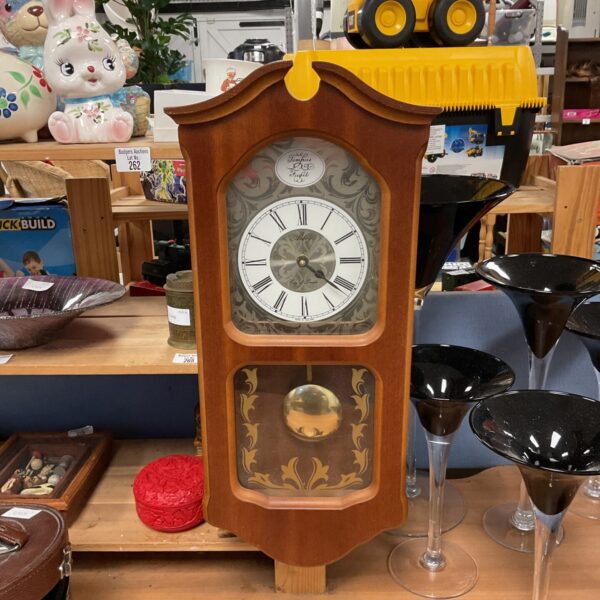 Vintage Lincoln wall clock with wooden case and Roman numerals.